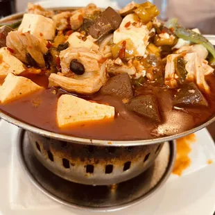 a hot pot with tofu and vegetables