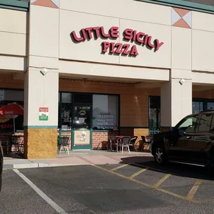 a car parked in front of a restaurant