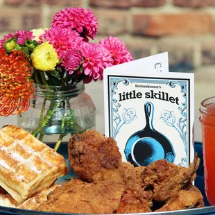 a plate of fried chicken, waffles, and a drink