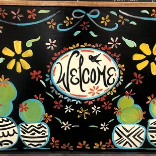 a painting of a welcome sign