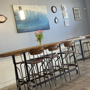 a row of tables and stools in a restaurant
