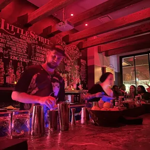 a bartender preparing drinks at a bar