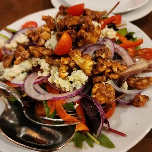 Mixed salad (pecans, onions, red peppers, blue cheese?, cherry tomatoes, greens) yum