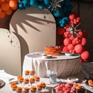 neon orange and pink desserts with vintage-style wedding cake