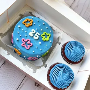 a birthday cake and cupcakes