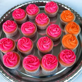 Bright pink and orange cupcakes with silver sprinkles to match the disco decor. Made by Little Sugar Crumb Sweets