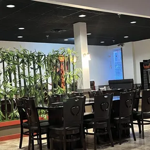 a dining area with tables and chairs