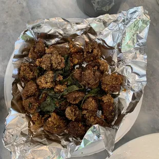 a plate of fried meat on a table