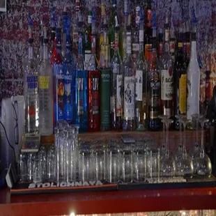a shelf of empty glasses