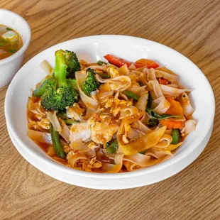 a bowl of noodles and broccoli