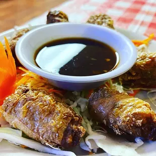 a plate of food with dipping sauce