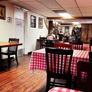a restaurant with red and white checkered tables and chairs