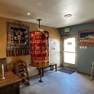 a room with a red and gold cloth hanging on the wall