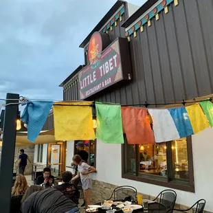 people eating outside of a restaurant