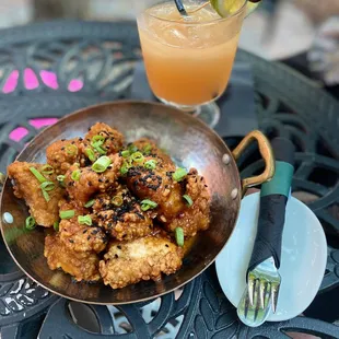 a plate of fried chicken and a drink