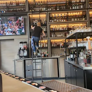 Bartender literally going top shelf to grab my selection.