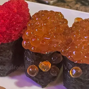 a plate of sushi rolls with gummy eyes