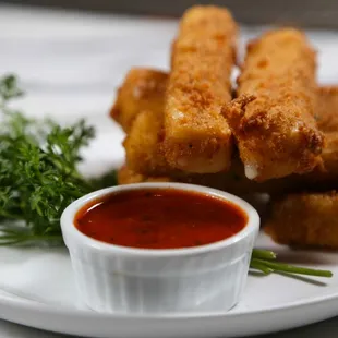 Golden mozzarella sticks with a side of marinara, crispy, cheesy, and absolutely delicious!