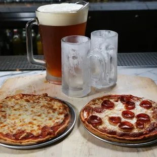 Two pizzas, a pitcher of beer, and mugs to share, cheers to great food with family and friends!