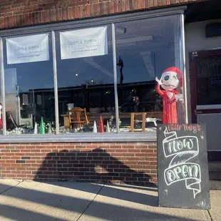 a storefront with a sign in front of it