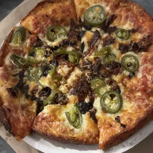 a pizza on a paper plate