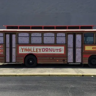 a trolley parked in front of a building