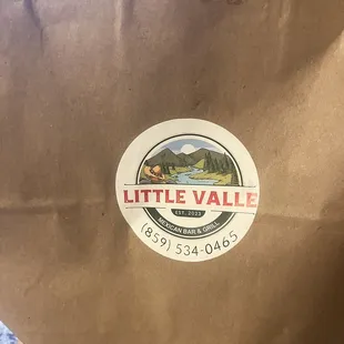 a brown paper bag with a sticker on it