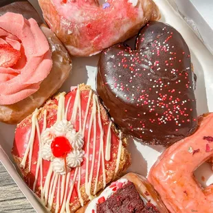 Valentines Day flight (neapolitan, vanilla glaze, white chocolate cherry, double chocolate filled, red velvet, and cardamom rose)