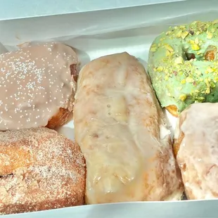 Flight (L-R): Cinnamon Sugar, Guava &amp; Cream Cheese Maple Bar, Pistachio, Classic Vanilla Glaze