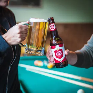 a man holding a beer and a woman holding a beer