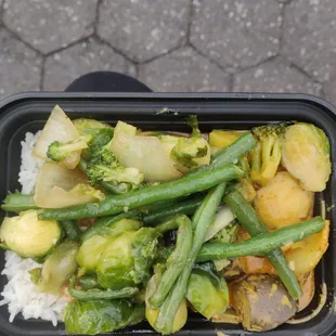 $5 lunch box with veggie curry and mixed vegetables on top