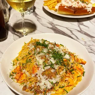 a plate of pasta and a glass of wine