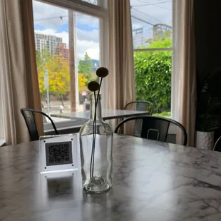 a glass bottle with a flower in it