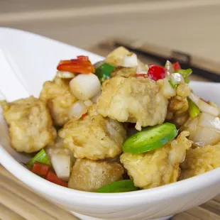 tofu in a white bowl with chopsticks