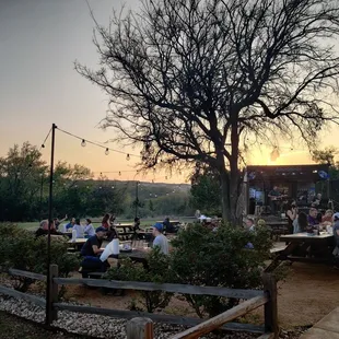 a group of people sitting at picnic tables