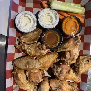 12 pc bone in wings with spicy garlic and Carolina bbq sauces on the side.