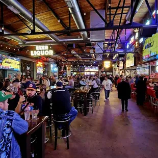 a crowded bar with people sitting at tables