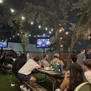 a group of people sitting at picnic tables