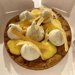 Ginger cookie base with dollops of cheesecake and lemon curd and candied ginger and lemon.