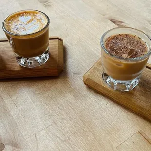 four different beverages on a wooden tray