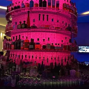 a pink tower of liquor bottles