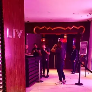 a group of people standing in front of a bar