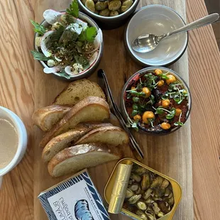 Olives, fava bean and avocado spread, heirloom tomatoes and hempseed, tinned mussels, and toasted sourdough