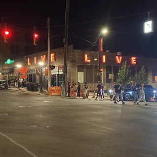people crossing the street at night