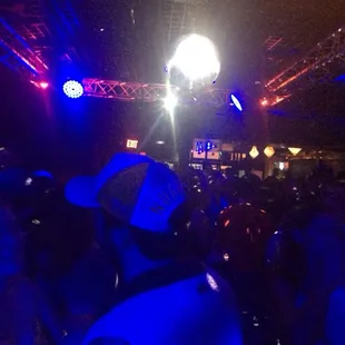 a crowd of people dancing at a nightclub