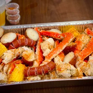 crab legs, potatoes, corn, corn on the cob, corn on the cob,
