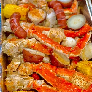 crab legs, potatoes, corn, and corn on the cob