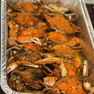 a pan of cooked crabs