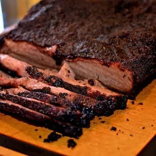 a close up of a bbq on a cutting board