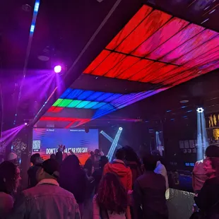 a crowd of people at a karaoke